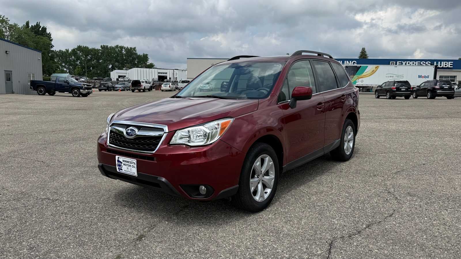 2016 Subaru Forester 2.5i Limited in Venetian Red Pearl — front three-quarter view