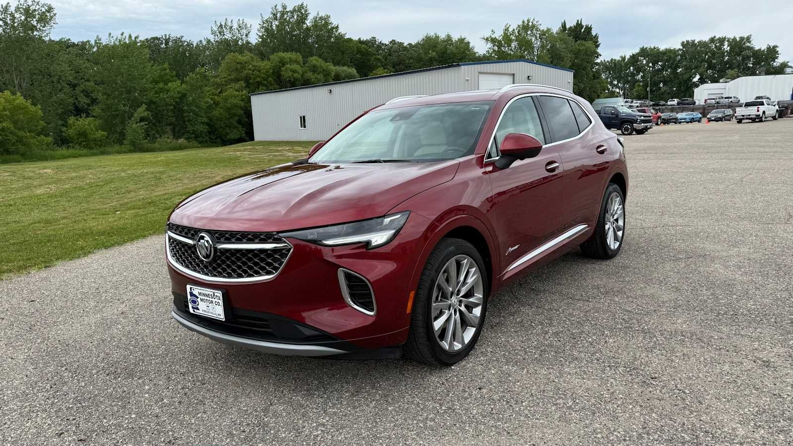 2023 Buick Envision Avenir in Cinnabar Metallic — front three-quarter view